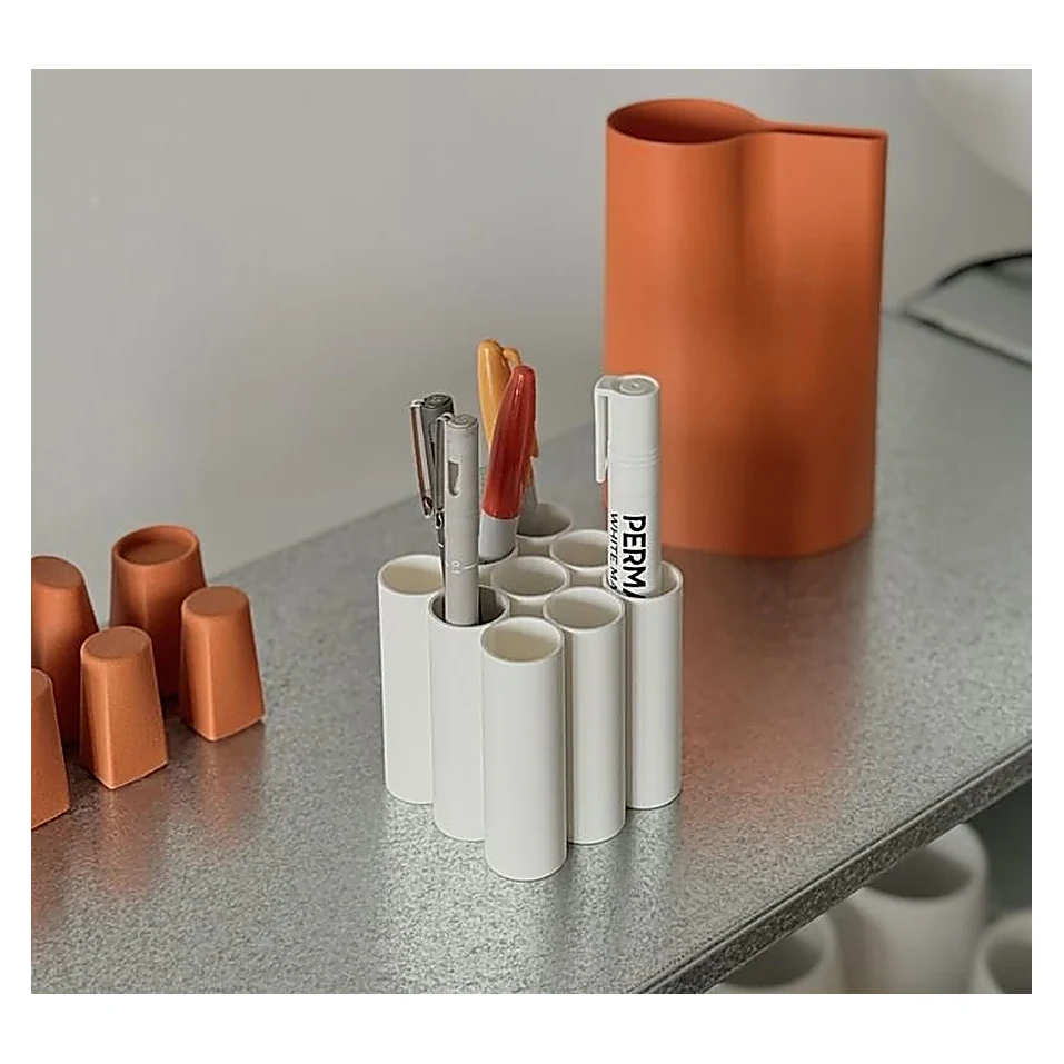 Orange Pen Cup on Metal Desk